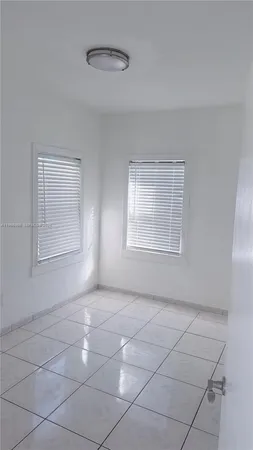 a view of an empty room with windows