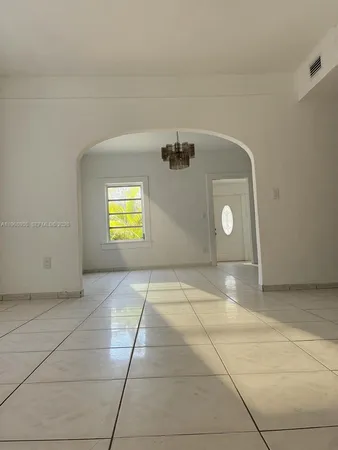 a view of a livingroom with wooden floor and a window