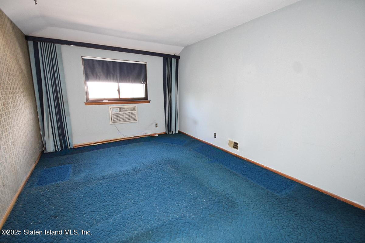 3 Windermere Road Staten Island, NY 10305 - Photo 14 of 37 a view of an empty room with wooden floor and a window