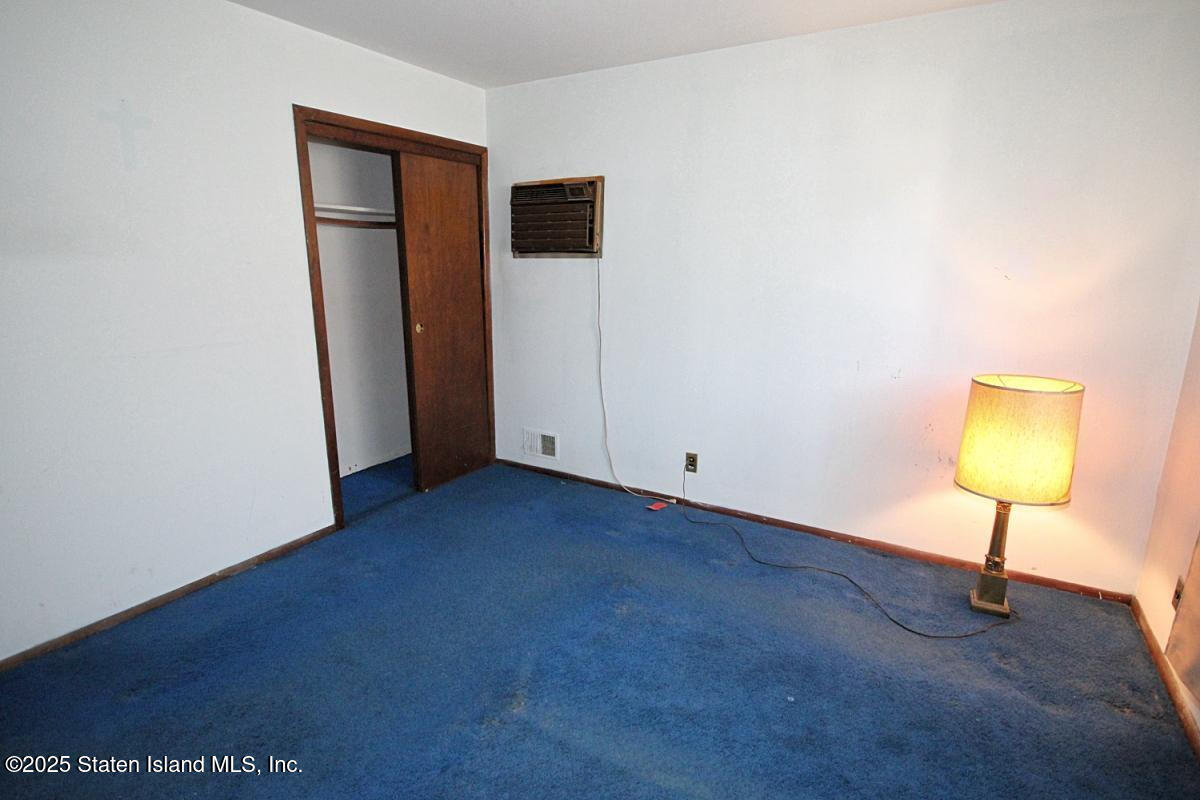 3 Windermere Road Staten Island, NY 10305 - Photo 27 of 37 a view of an empty room with a window and a lamp