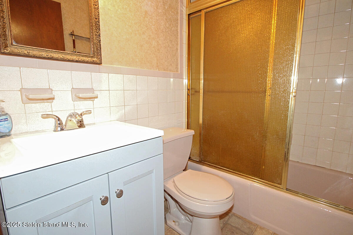 3 Windermere Road Staten Island, NY 10305 - Photo 29 of 37 a bathroom with a sink a toilet and shower