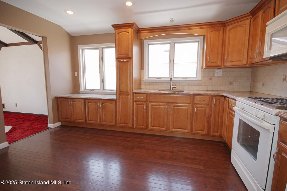 3 Windermere Road Staten Island, NY 10305 - Photo 8 of 37 a view of a kitchen with a sink dishwasher and wooden floor
