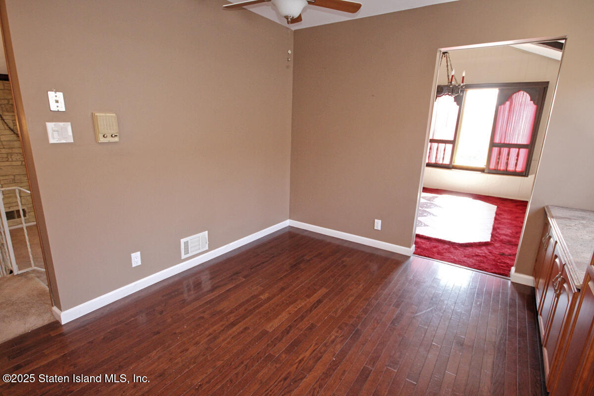 3 Windermere Road Staten Island, NY 10305 - Photo 9 of 37 a view of empty room with wooden floor and fan