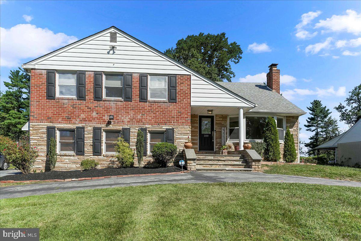 200 North State Road Springfield, PA 19064 - Photo 1 of 46 a front view of a house with swimming pool and sitting area