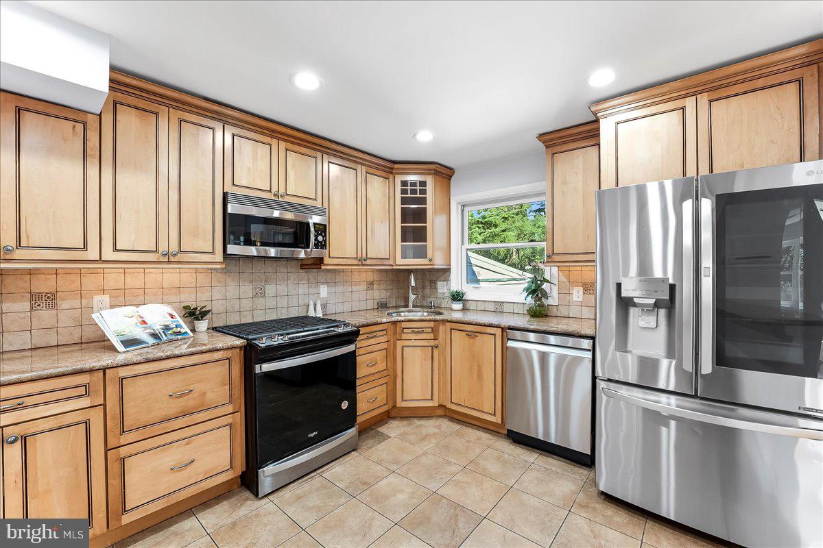 200 North State Road Springfield, PA 19064 - Photo 11 of 46 a kitchen with stainless steel appliances granite countertop a refrigerator stove and sink