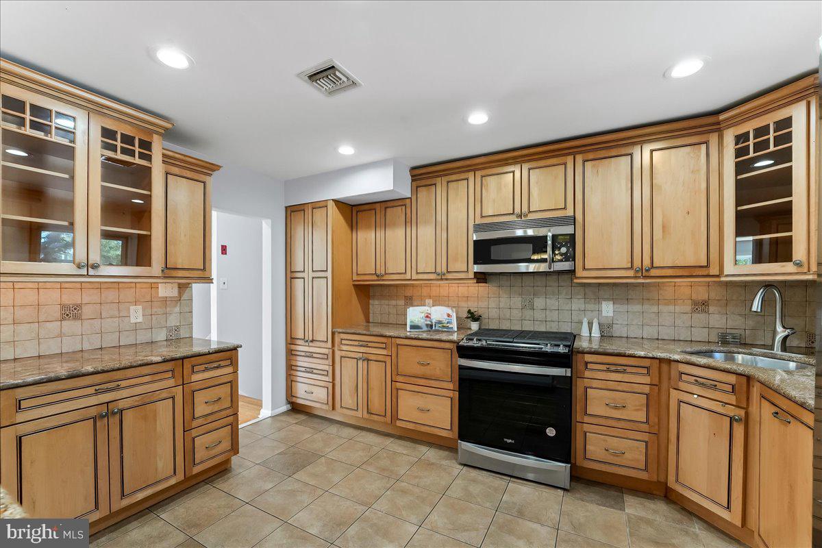 200 North State Road Springfield, PA 19064 - Photo 12 of 46 a kitchen with stainless steel appliances granite countertop a stove and cabinets