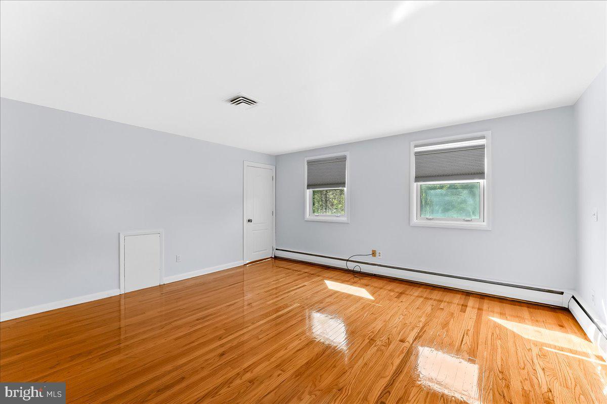 200 North State Road Springfield, PA 19064 - Photo 18 of 46 an empty room with wooden floor and windows
