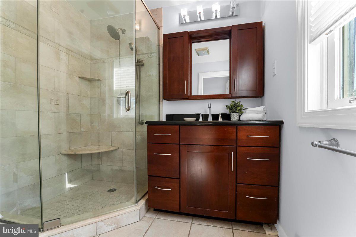 200 North State Road Springfield, PA 19064 - Photo 19 of 46 a bathroom with a sink mirror and shower