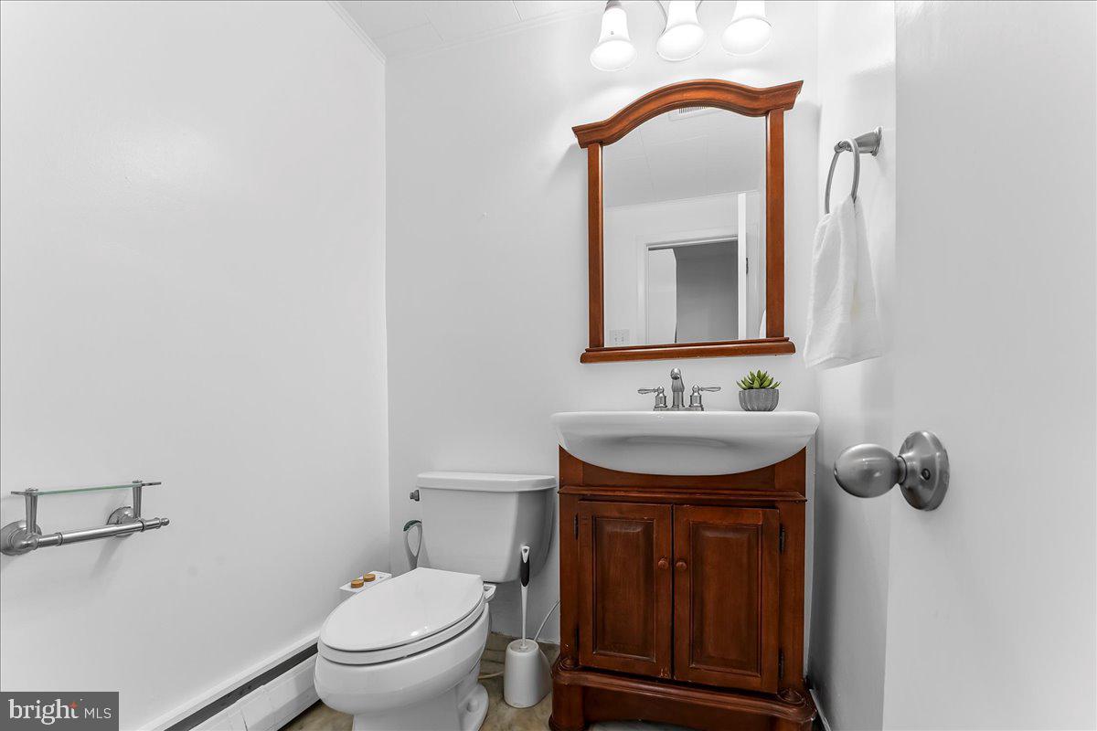 200 North State Road Springfield, PA 19064 - Photo 23 of 46 a bathroom with a toilet sink and mirror