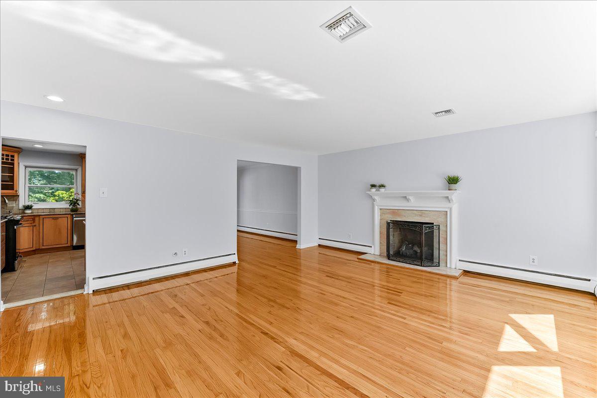 200 North State Road Springfield, PA 19064 - Photo 4 of 46 a view of empty room with wooden floor and fireplace