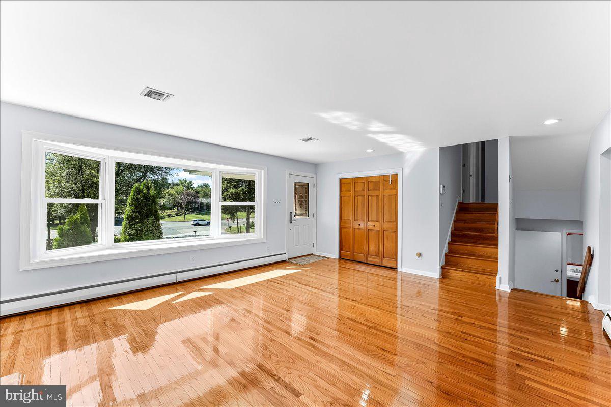 200 North State Road Springfield, PA 19064 - Photo 6 of 46 a view of an empty room with wooden floor and a window