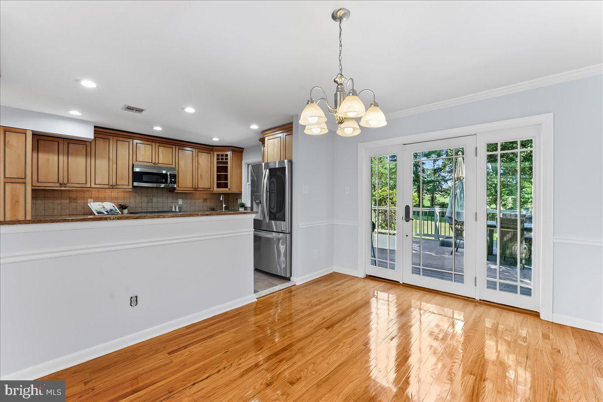 200 North State Road Springfield, PA 19064 - Photo 8 of 46 a kitchen with stainless steel appliances granite countertop a refrigerator a stove top oven a sink dishwasher and wooden floor