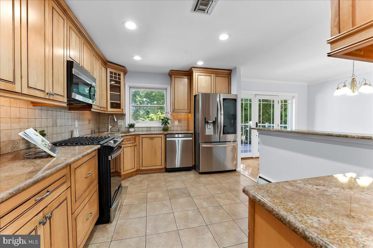 200 North State Road Springfield, PA 19064 - Photo 10 of 46 a kitchen with granite countertop a sink a counter top space stainless steel appliances and cabinets