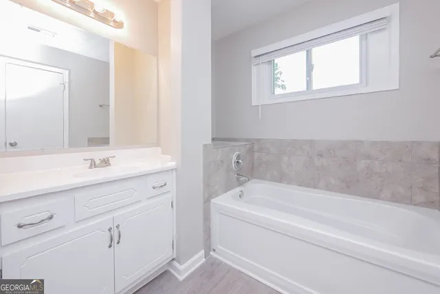 a bathroom with a bathtub and a sink
