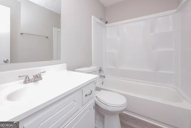 a bathroom with a sink a toilet and a bathtub