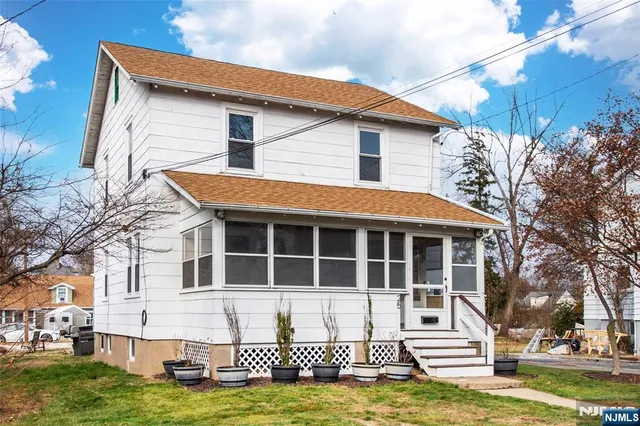 a view of a house with a yard and sitting area