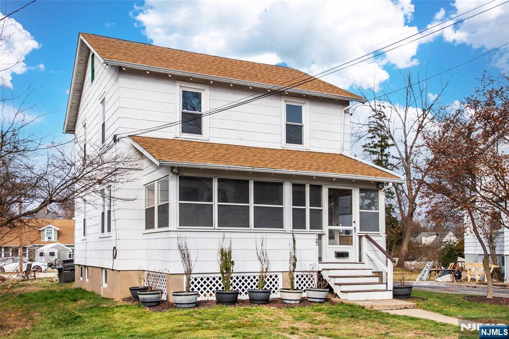 a view of a house with a yard and sitting area