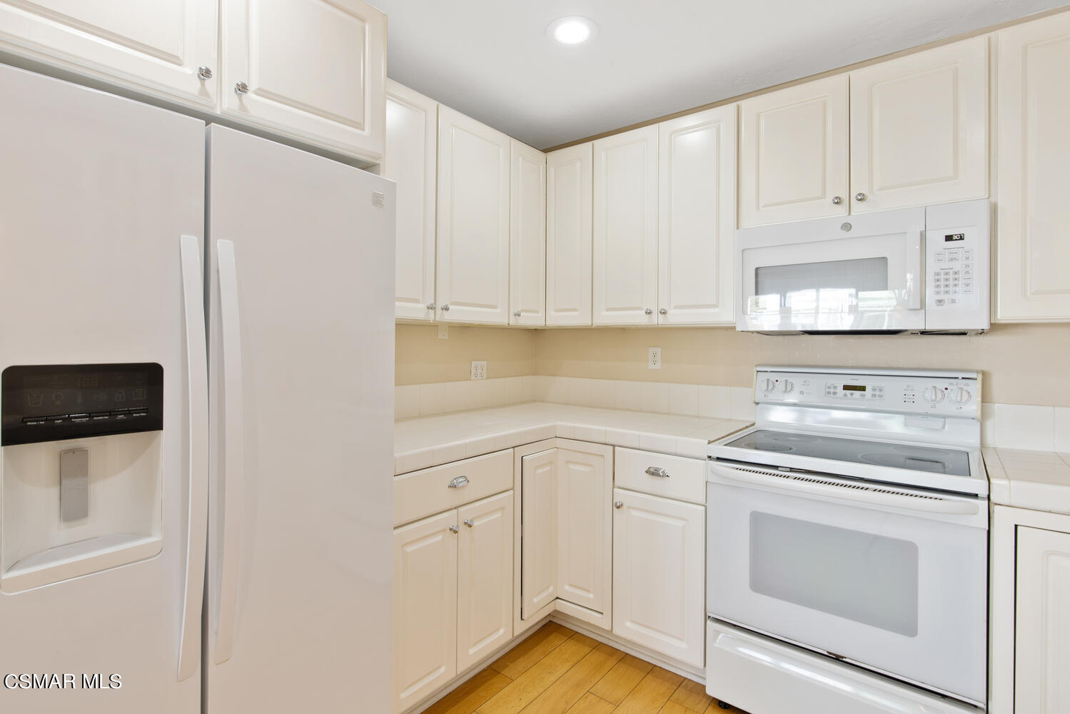 1657 Dockside Lane Camarillo, CA 93010 - Photo 9 of 22 a kitchen with white cabinets and white appliances