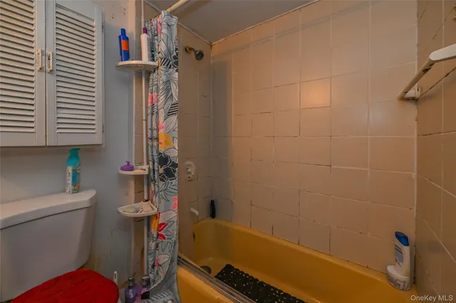 a bathroom with a granite countertop toilet sink and tub
