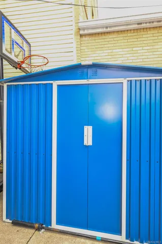 a brick building with a potted plant on it