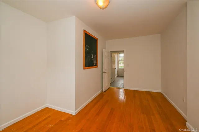 a view of a room with wooden floor and window