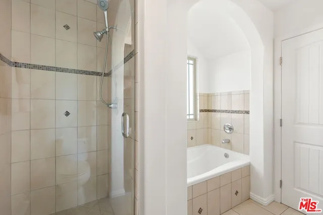 a bathroom with a tub a sink and a shower