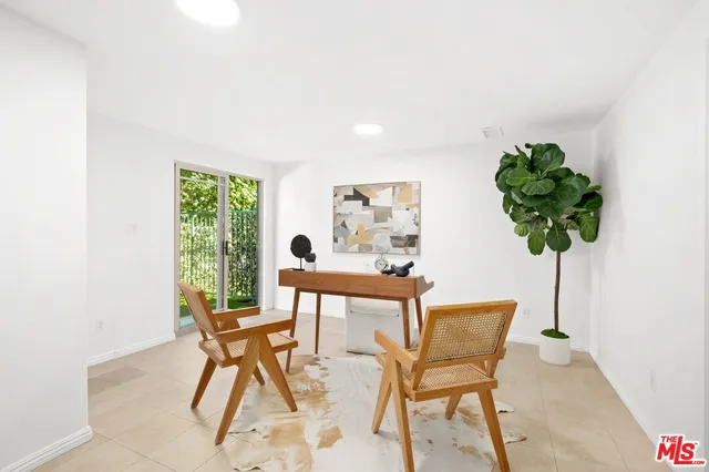 a dining room with furniture and a potted plant
