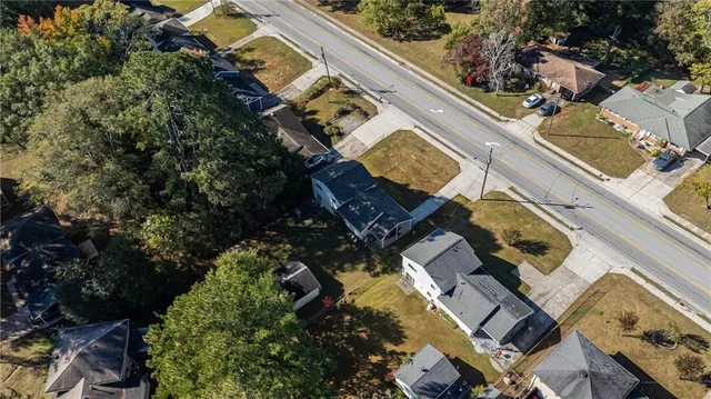 an aerial view of a house with a yard