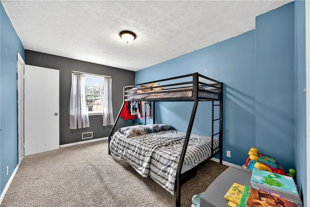 a bedroom with a bed and a baby crib