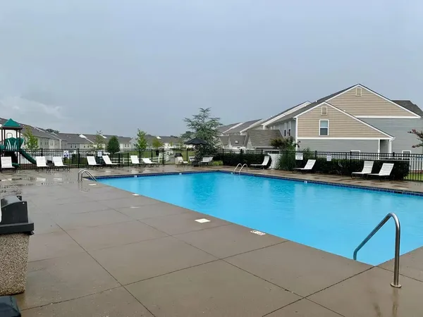 a view of swimming pool with outdoor seating and plants