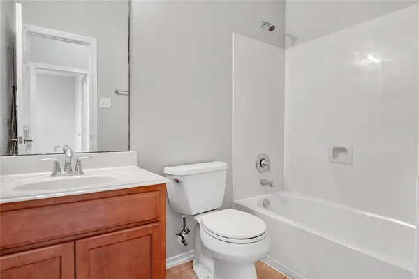 a bathroom with a sink toilet vanity and tub