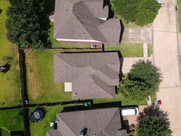 an aerial view of a house with a yard