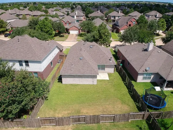 an aerial view of a house with garden space and street view
