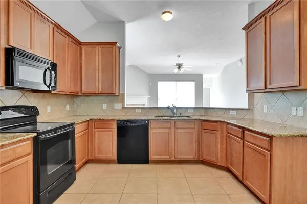 a kitchen with stainless steel appliances granite countertop a stove sink microwave and cabinets