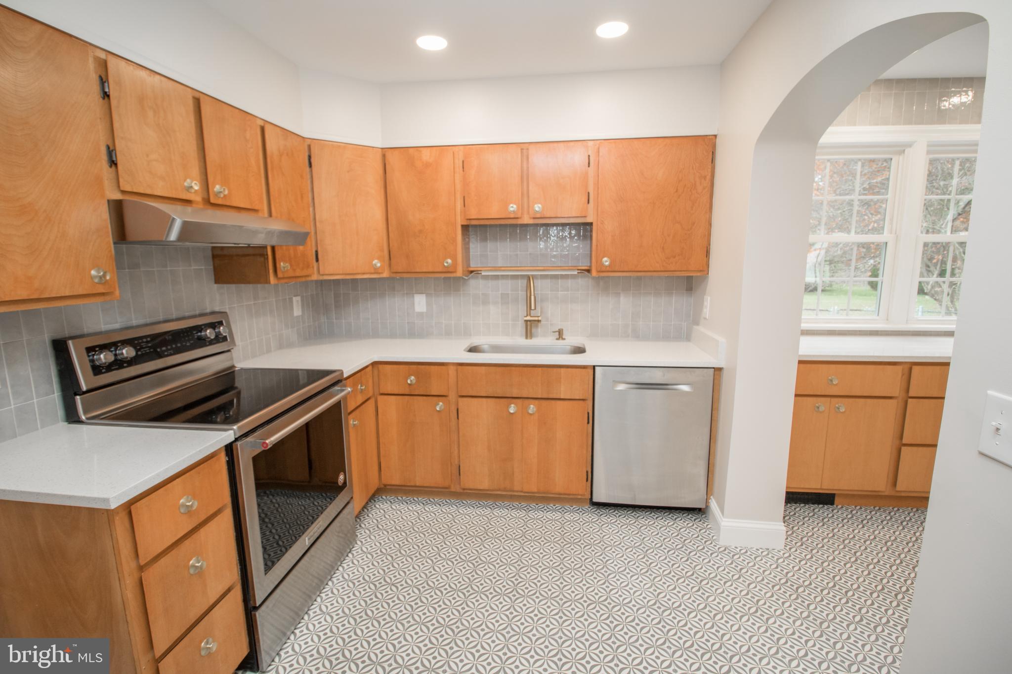 20697 Chingville Road Leonardtown, MD 20650 - Photo 38 of 87 a kitchen with a stove top oven sink and cabinets