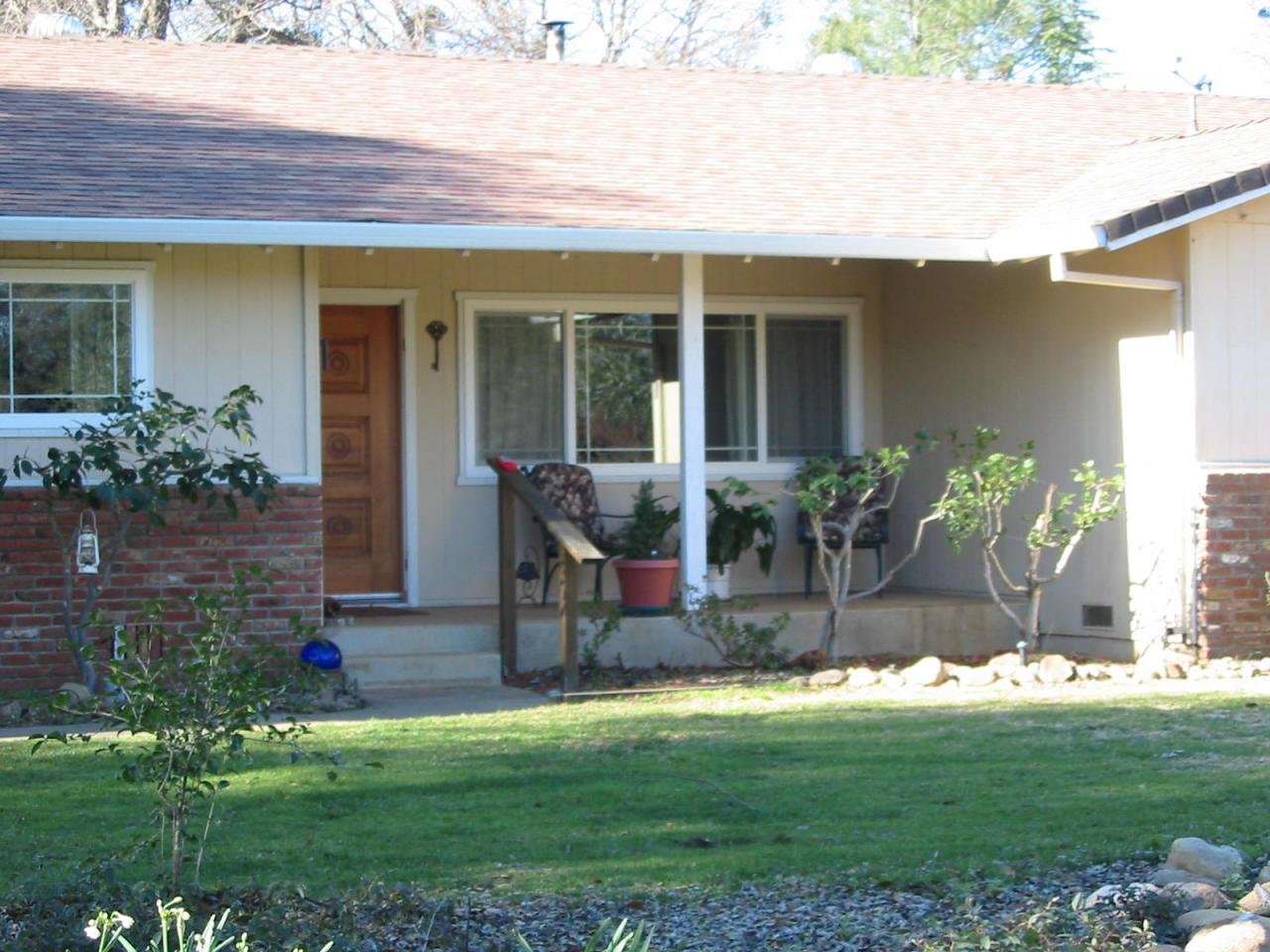 21334 Dersch Road Anderson, CA 96007 - Photo 4 of 24 a front view of a house with a yard and potted plants