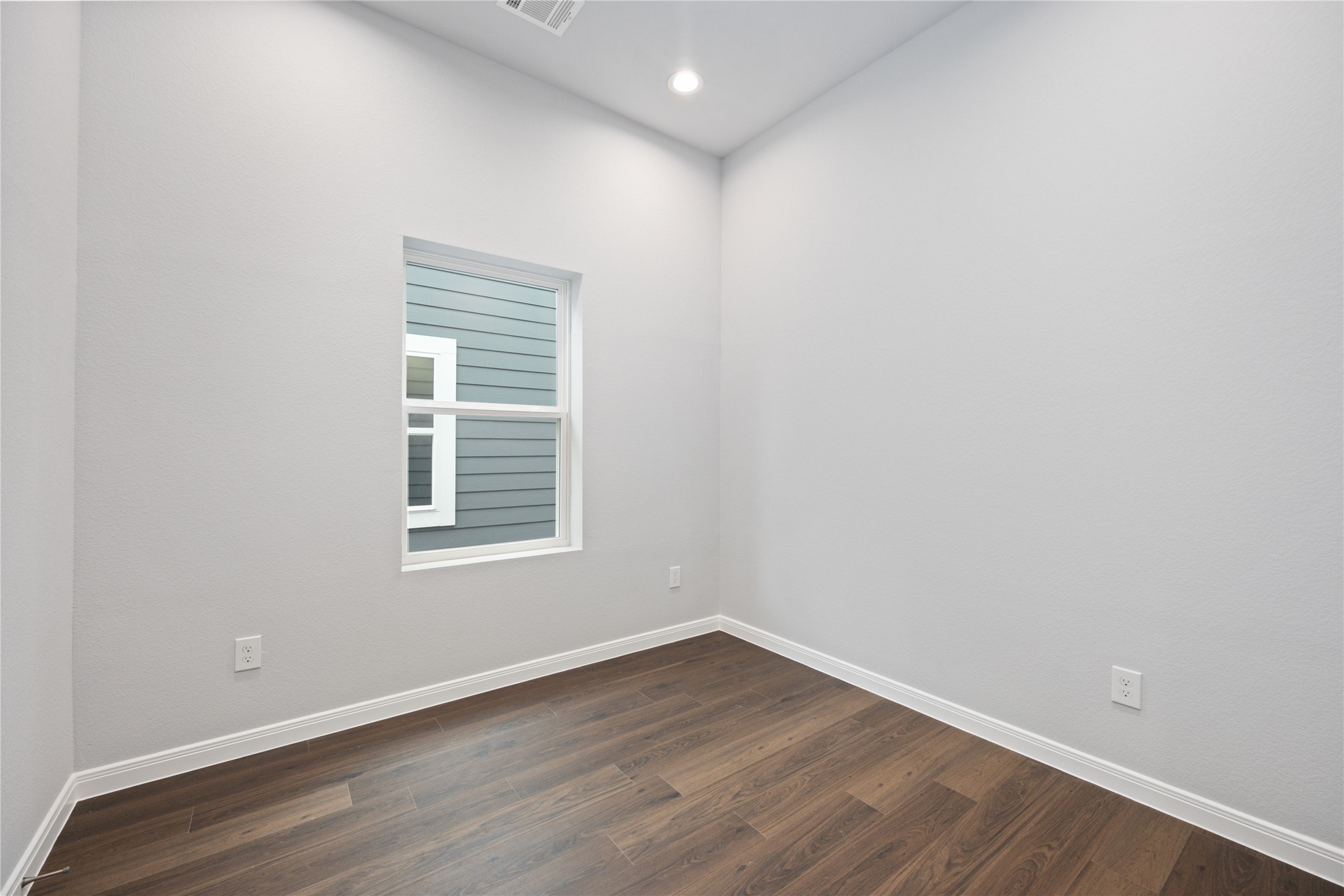 18831 Luminescent Ln Spring Spring, TX 77379 - Photo 26 of 36 an empty room with wooden floor and a window