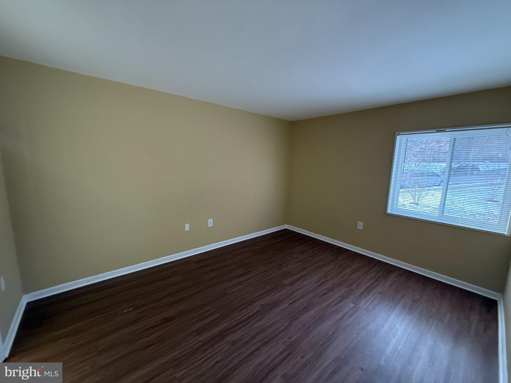 1403 Northgate Square, Unit 12B Reston, VA 20190 - Photo 11 of 16 a view of an empty room with wooden floor and a window