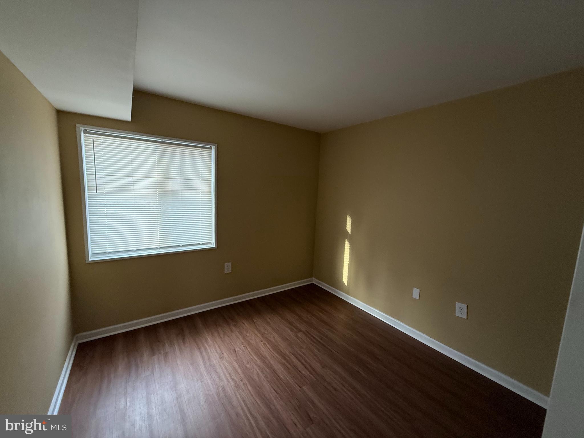 1403 Northgate Square, Unit 12B Reston, VA 20190 - Photo 15 of 16 an empty room with wooden floor and windows