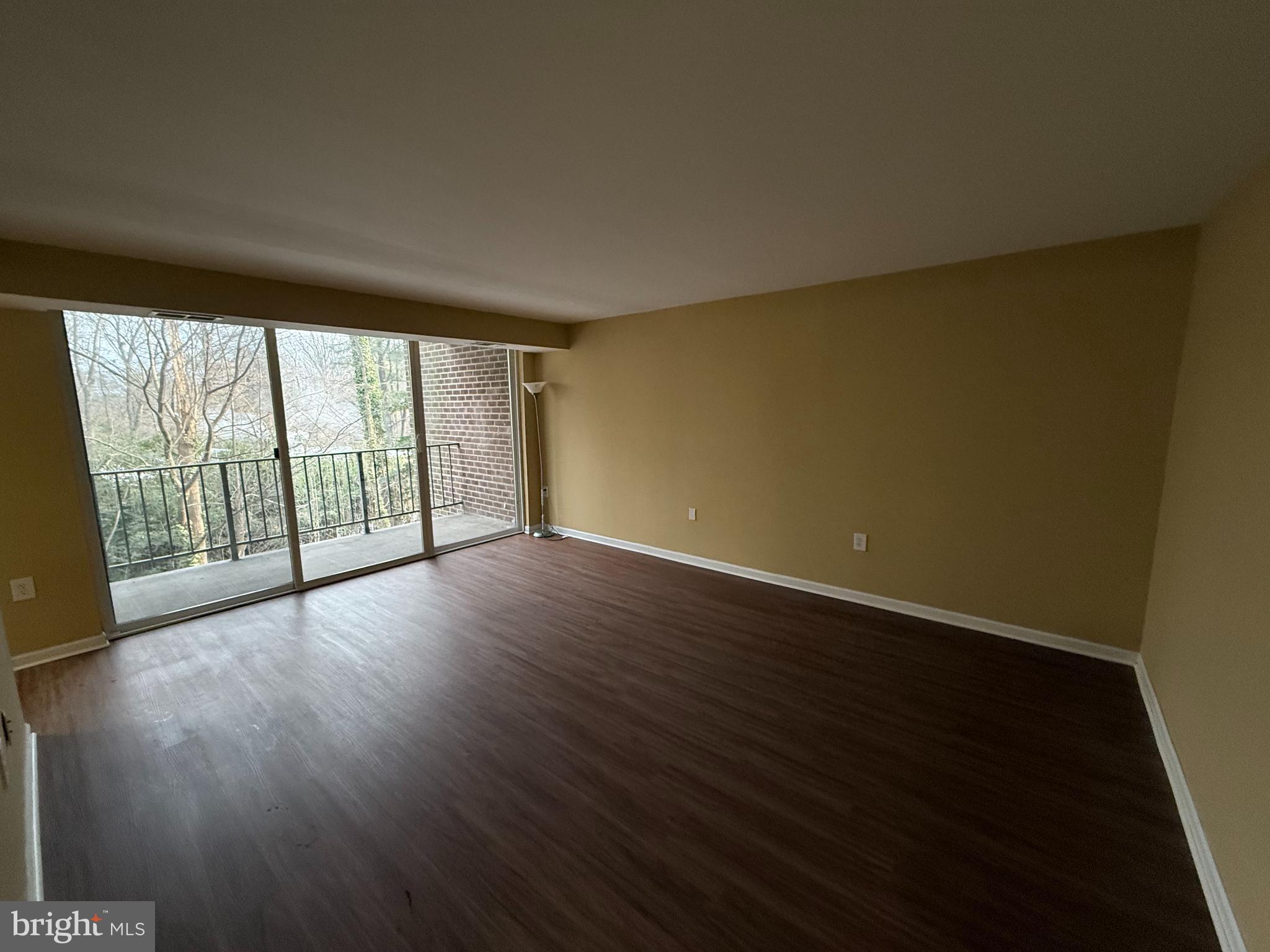 1403 Northgate Square, Unit 12B Reston, VA 20190 - Photo 3 of 16 a view of an empty room with wooden floor and a window