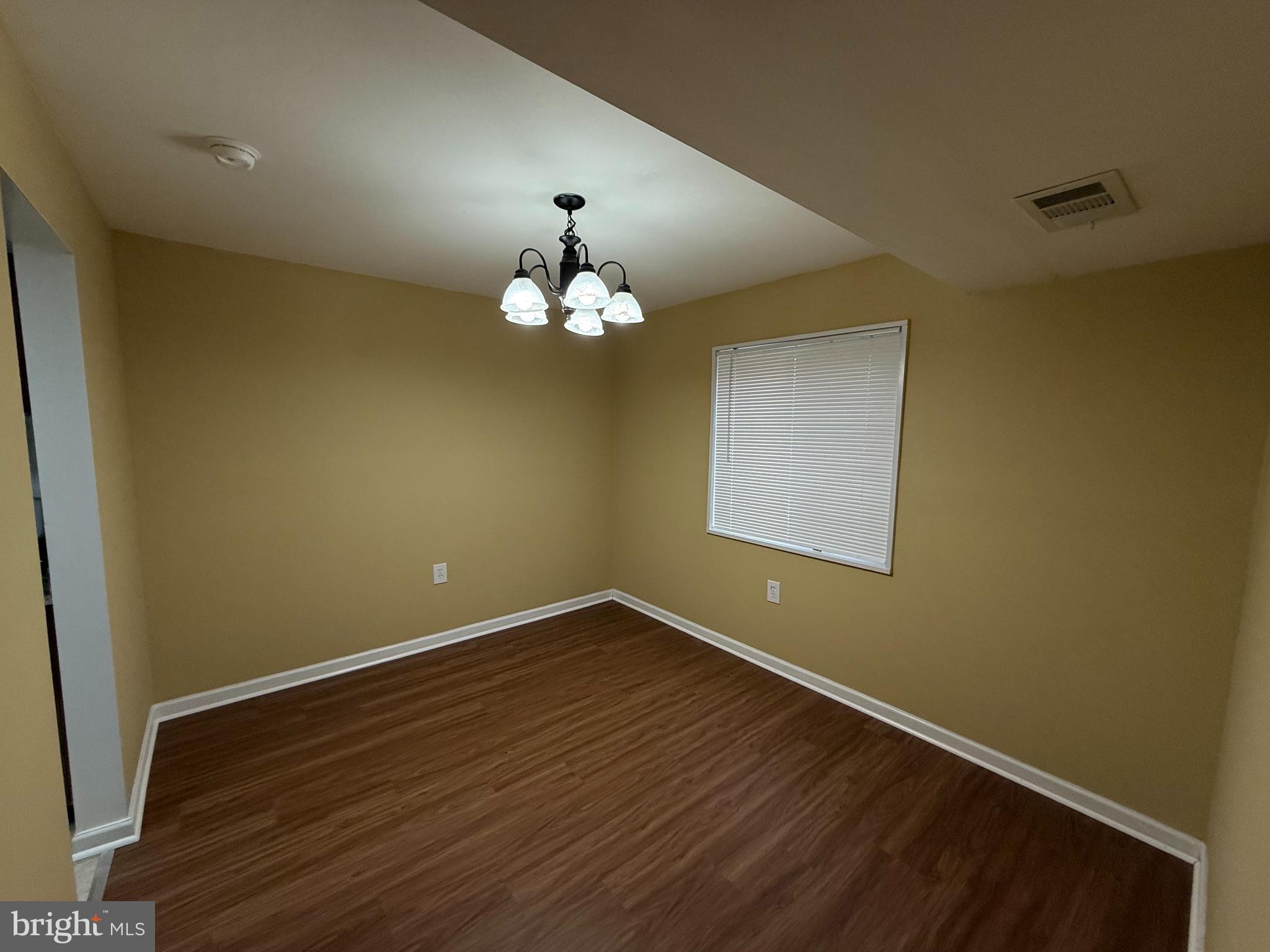 1403 Northgate Square, Unit 12B Reston, VA 20190 - Photo 5 of 16 a view of wooden floor and chandelier in a room
