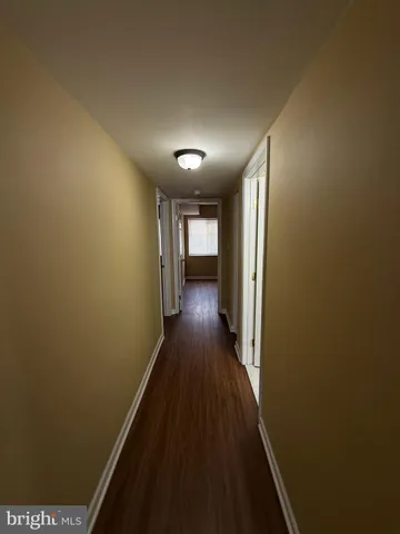 a view of hallway with wooden floor