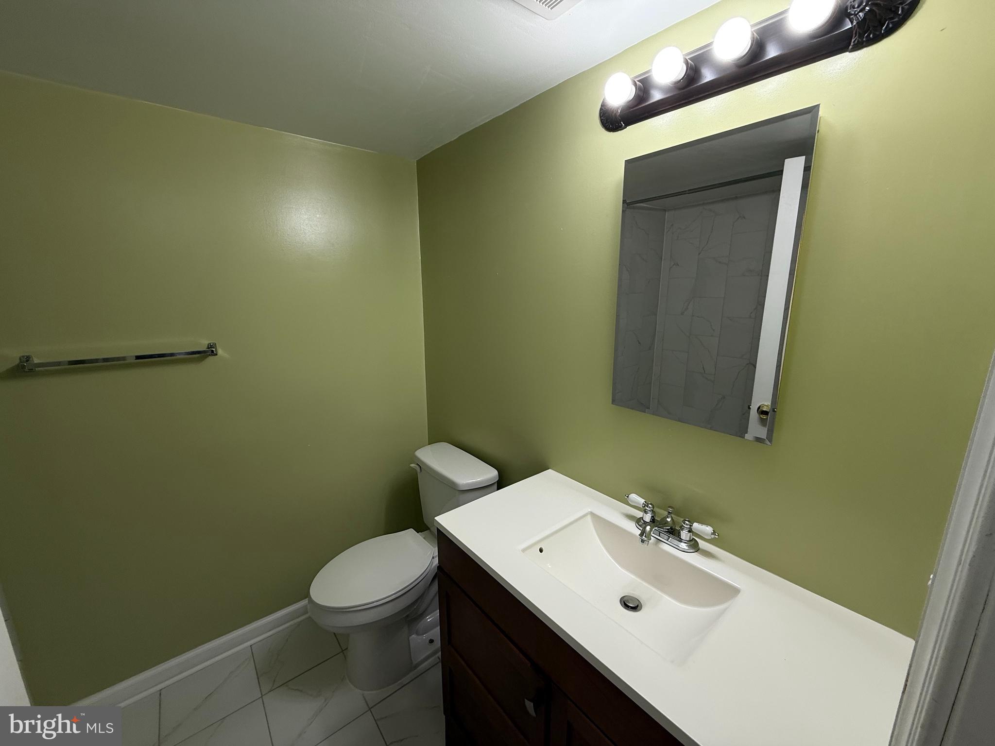 1403 Northgate Square, Unit 12B Reston, VA 20190 - Photo 9 of 16 a bathroom with a sink mirror vanity and toilet