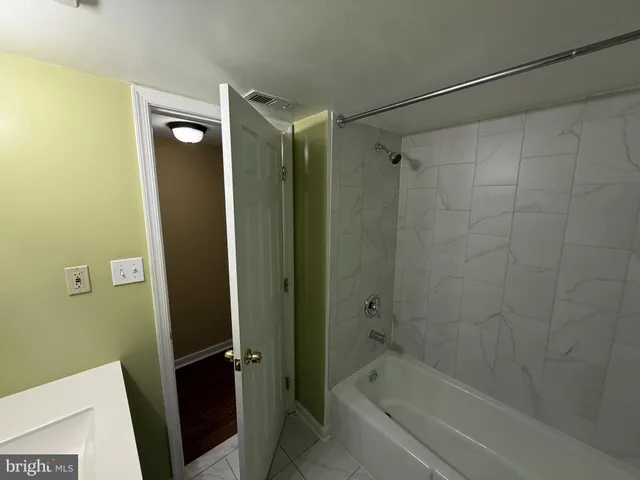 a bathroom with a shower and a bath tub