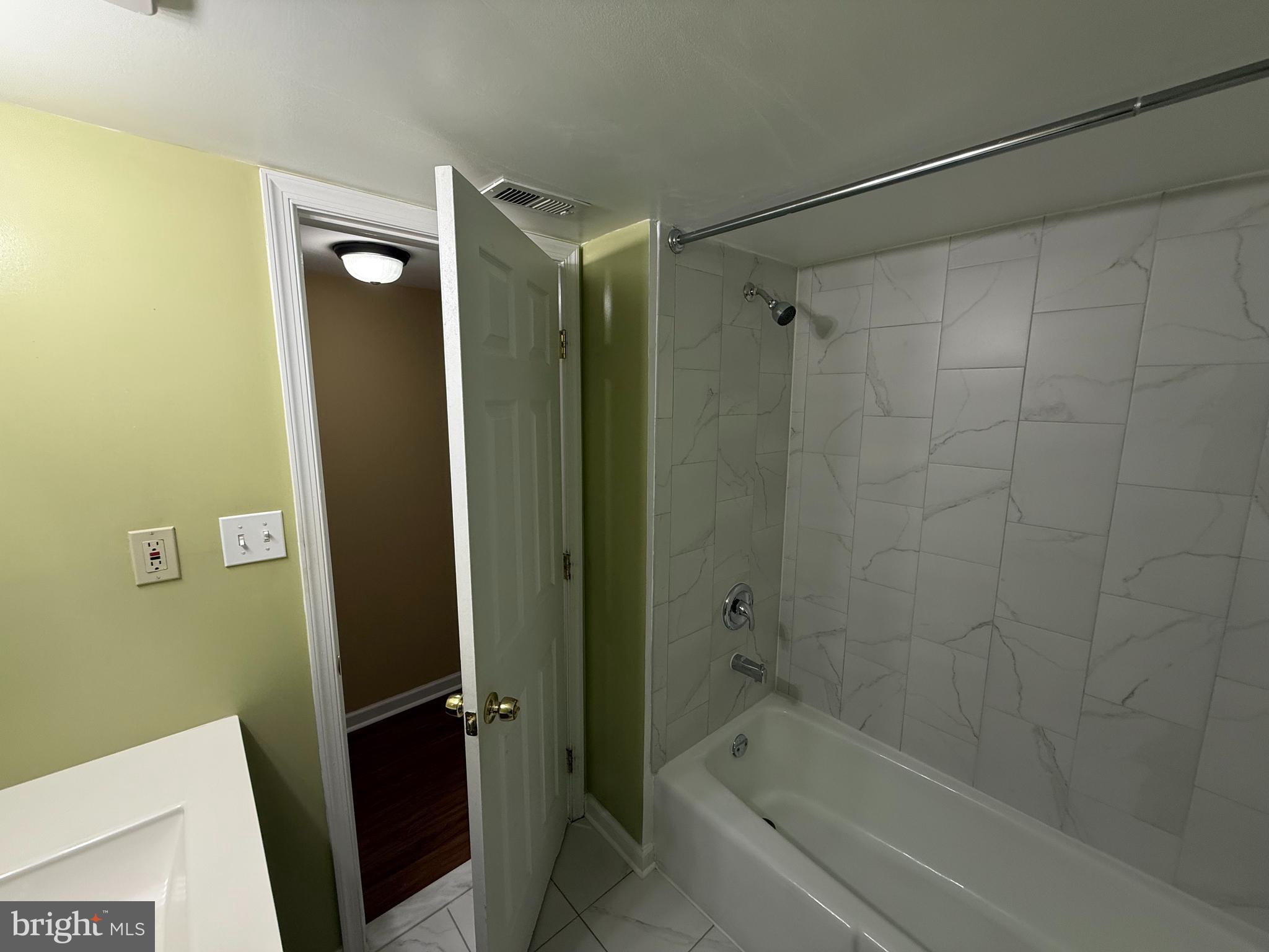 1403 Northgate Square, Unit 12B Reston, VA 20190 - Photo 10 of 16 a bathroom with a shower and a bath tub