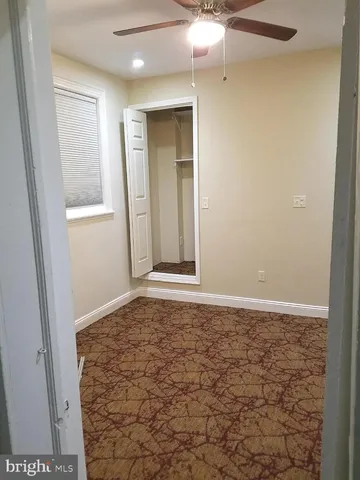 en empty room with window and hardwood floor