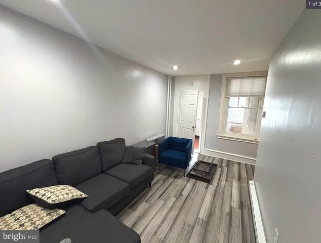 a living room with furniture and a rug