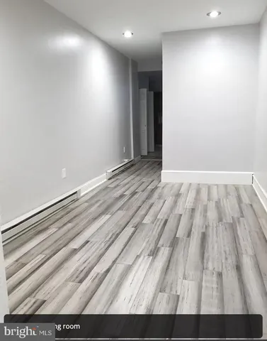 a view of room with wooden floor