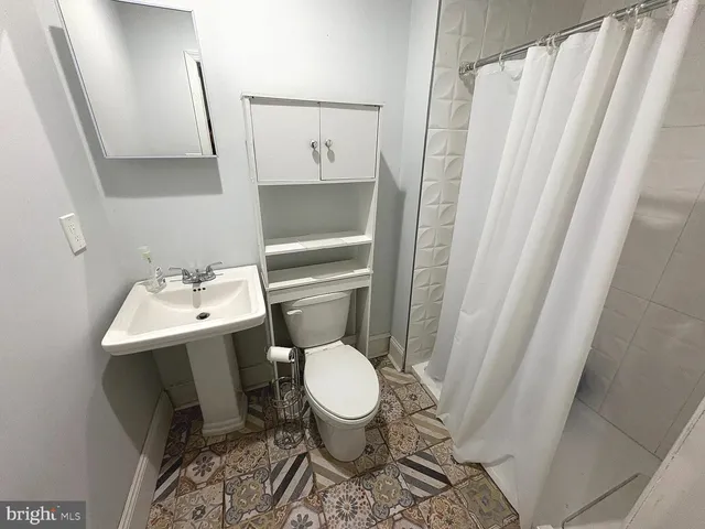 a white toilet sitting next to a small sink