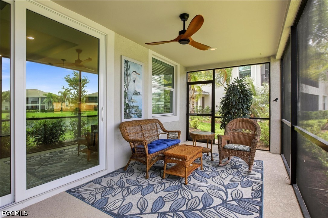 3751 Pebblebrook Ridge Court, Unit 101 Fort Myers, FL 33905 - Photo 39 of 48 a living room with furniture and a floor to ceiling window